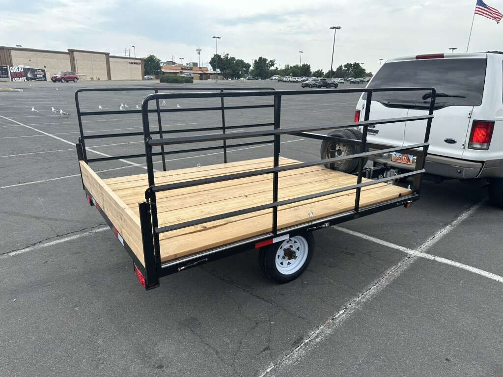 Double ATV utility trailer with wood deck and fold-down side ramps